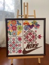 لوحة تطريز يدوي بتصميم فسيفسائي مع لمسة عصرية من شعار نايك